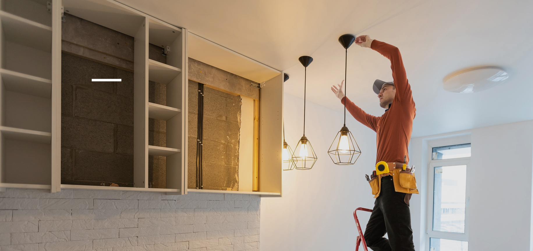 Electrician installing pendant lights in a home